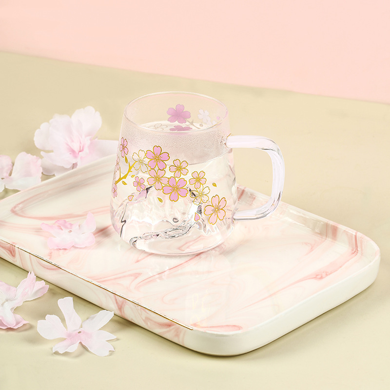 Taza de agua de cristal que cambia de color de flor de cerezo romántica